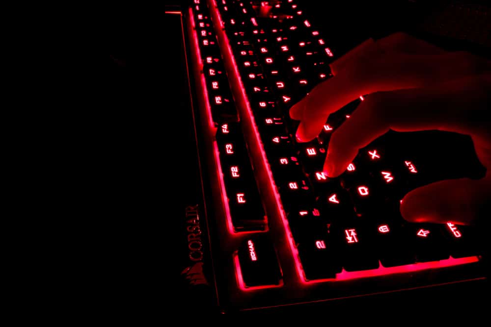 Someone typing on an MSI keyboard having a red lightning