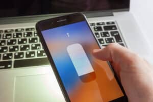 An iPhone flashlight illuminating a laptop keyboard